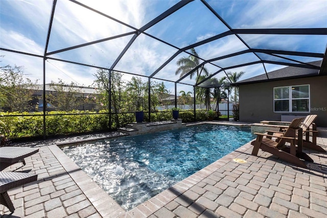 pool with a lanai and a patio area