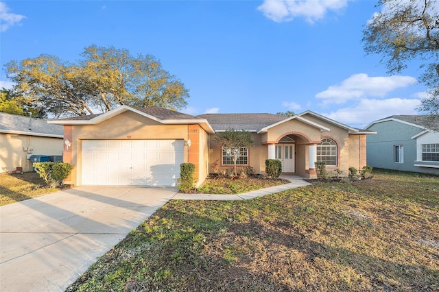 single story home featuring a front yard and a garage