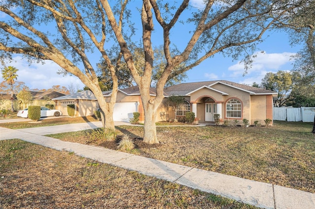 ranch-style home featuring a front yard and a garage