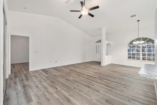 unfurnished living room featuring high vaulted ceiling, ceiling fan with notable chandelier, and light wood-type flooring