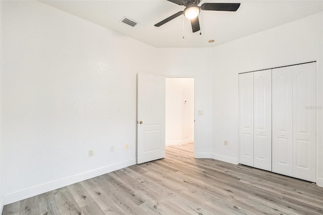 unfurnished bedroom with ceiling fan, a closet, and light hardwood / wood-style flooring