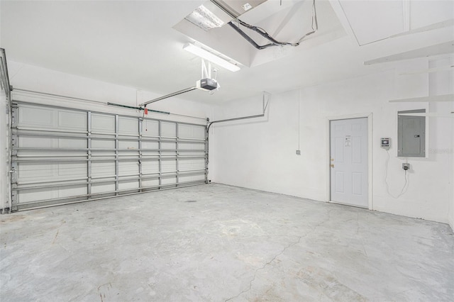 garage featuring electric panel and a garage door opener