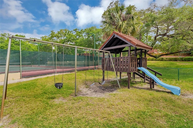 view of jungle gym with tennis court and a yard