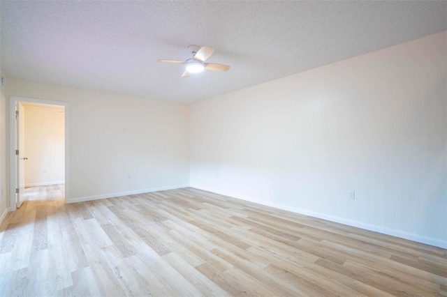 spare room featuring a textured ceiling, ceiling fan, and light hardwood / wood-style floors