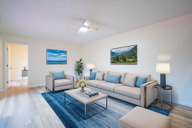 living room featuring ceiling fan, a textured ceiling, and hardwood / wood-style floors