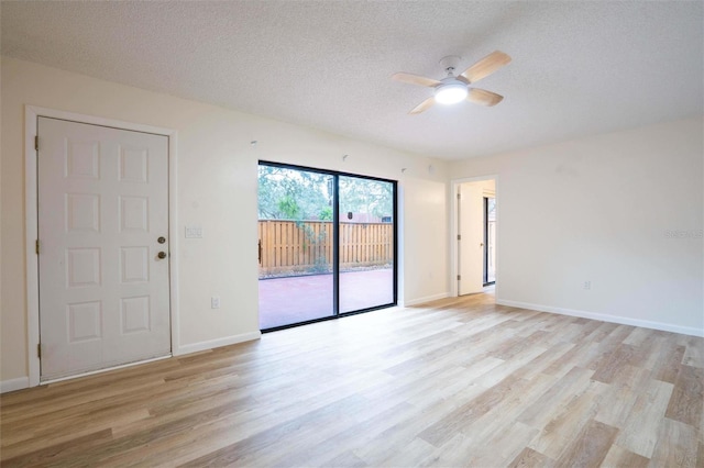 spare room featuring ceiling fan, a textured ceiling, and light wood-type flooring