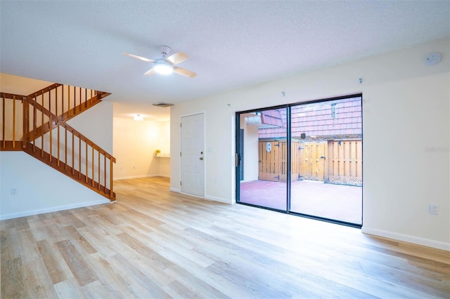 unfurnished room with light hardwood / wood-style floors, a textured ceiling, and ceiling fan