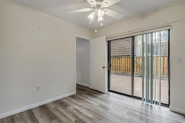 unfurnished room featuring ceiling fan, a textured ceiling, and light hardwood / wood-style flooring