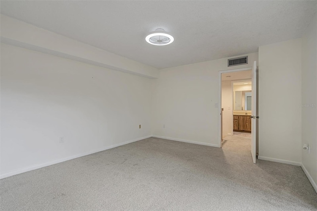 unfurnished room featuring light colored carpet