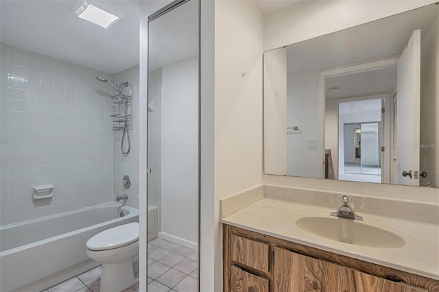 full bathroom with toilet, tile patterned flooring, tiled shower / bath combo, and vanity