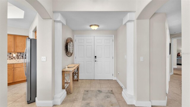 entrance foyer with light tile patterned floors