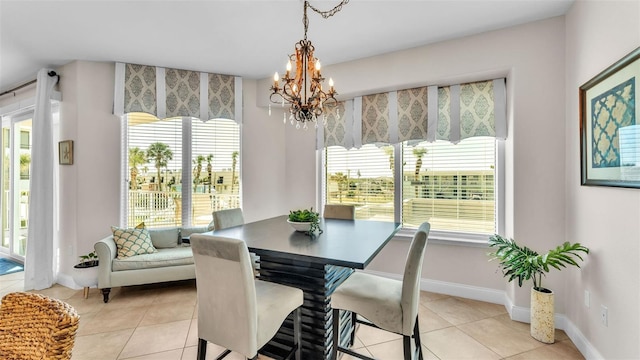 tiled dining area with a chandelier