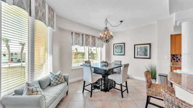 tiled dining area featuring an inviting chandelier