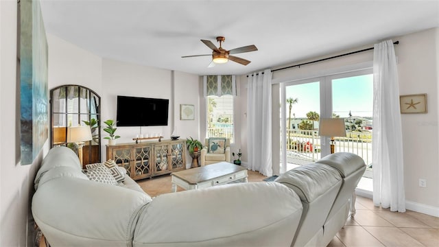 tiled living room featuring ceiling fan