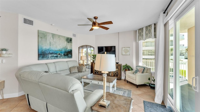 tiled living room with ceiling fan and a healthy amount of sunlight