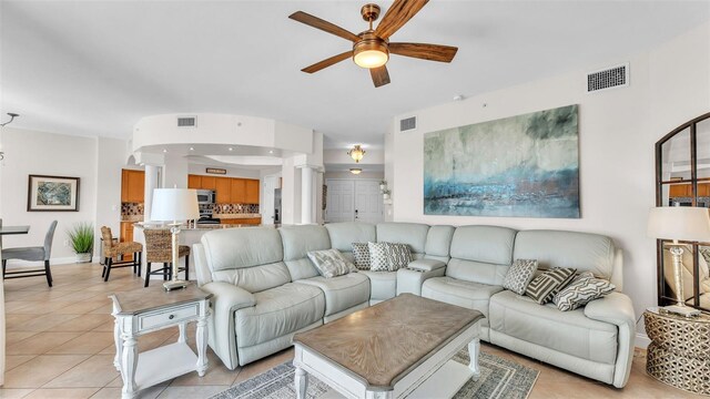 living room with light tile patterned floors and ceiling fan