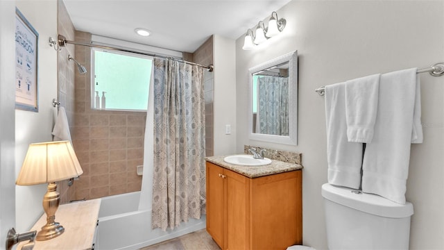 full bathroom featuring shower / bath combination with curtain, toilet, and vanity