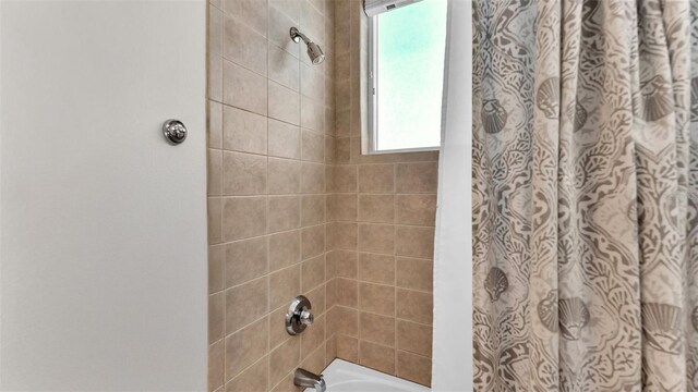 bathroom with shower / bathtub combination with curtain