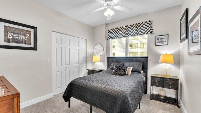 bedroom featuring ceiling fan, a closet, and light carpet