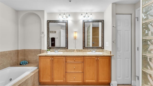 bathroom with vanity and a relaxing tiled tub