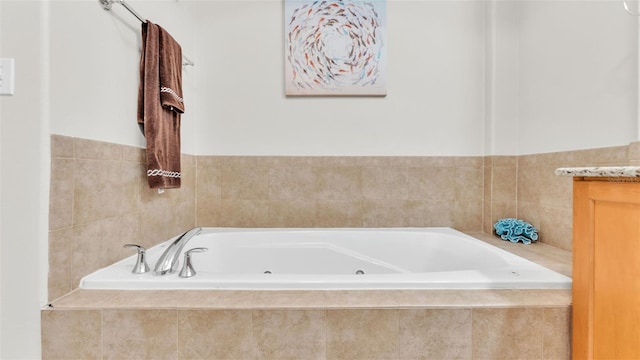 bathroom with vanity and a relaxing tiled tub