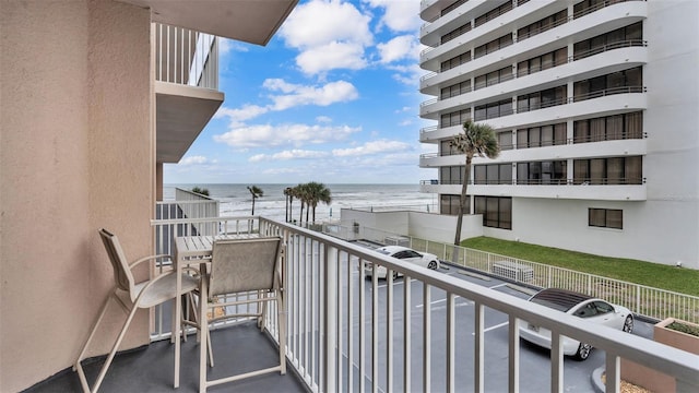 balcony with a beach view and a water view