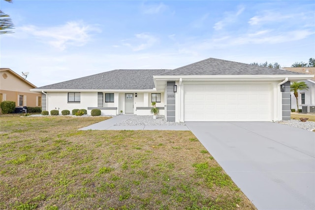 single story home with central AC, a front yard, and a garage