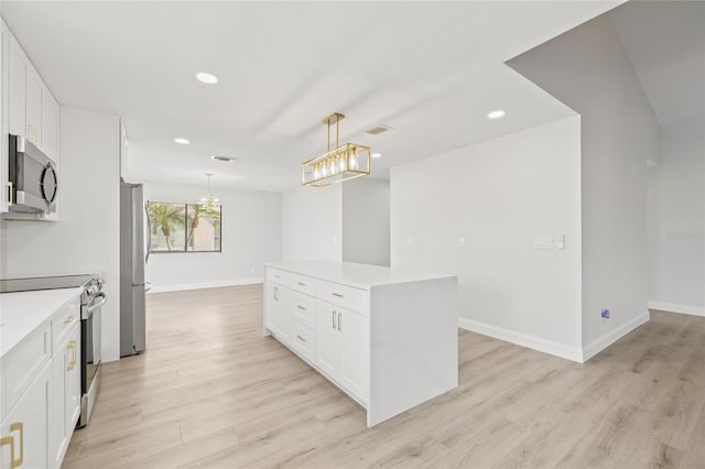 kitchen with a center island, light hardwood / wood-style floors, pendant lighting, white cabinets, and appliances with stainless steel finishes