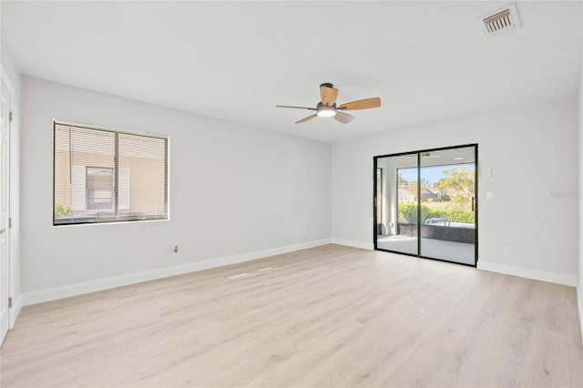 empty room with light hardwood / wood-style flooring and ceiling fan