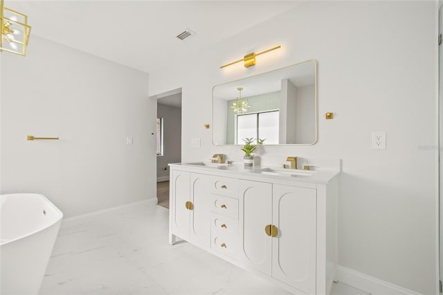 bathroom featuring a washtub and vanity