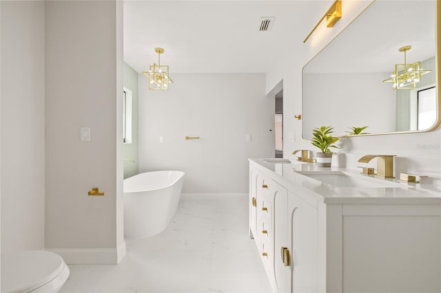 bathroom featuring vanity, a tub to relax in, and toilet