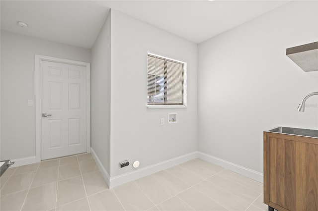 laundry room with washer hookup, light tile patterned floors, and sink