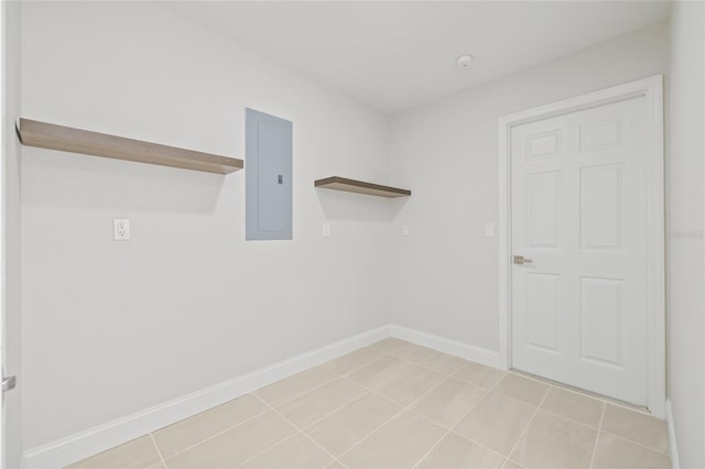 laundry room with electric panel and light tile patterned flooring