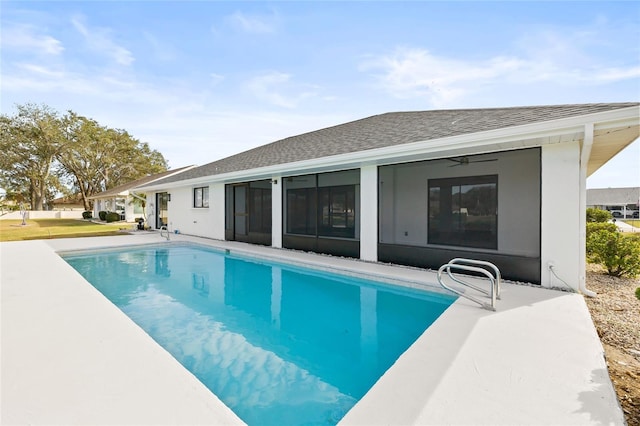 view of swimming pool with a sunroom and ceiling fan