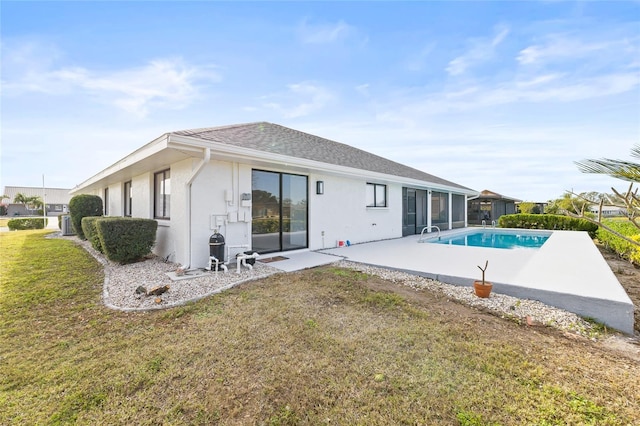 rear view of house with a yard and a patio