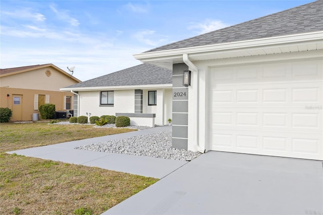 single story home with central air condition unit and a front yard