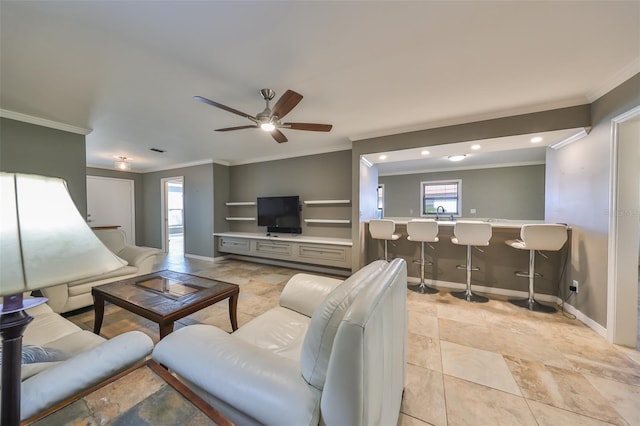 living room featuring built in features, ceiling fan, ornamental molding, and sink