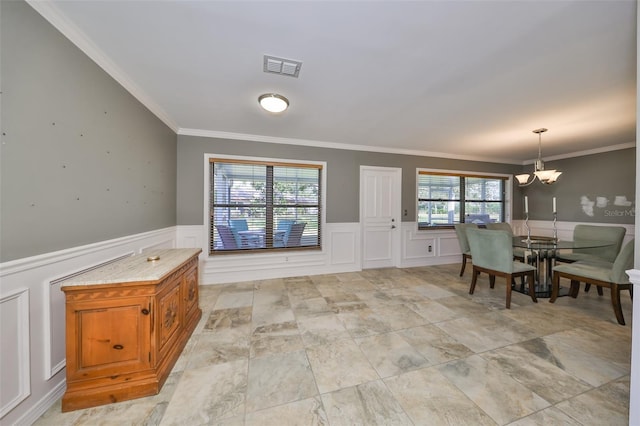 dining area featuring a notable chandelier, plenty of natural light, and ornamental molding