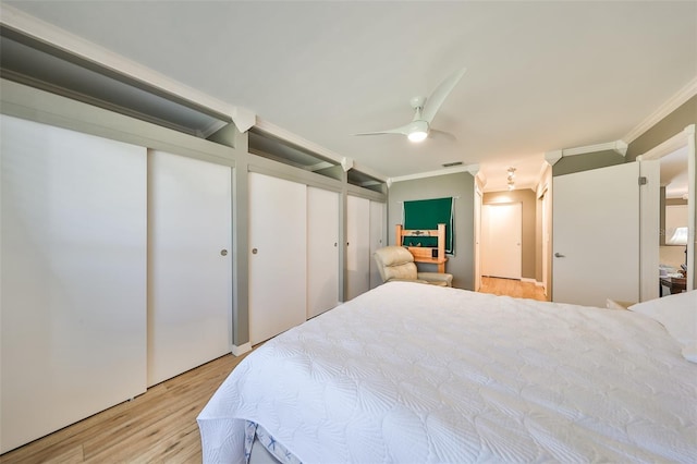 bedroom with light hardwood / wood-style floors, ceiling fan, and crown molding