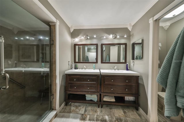 bathroom featuring toilet, vanity, a shower with shower door, and ornamental molding