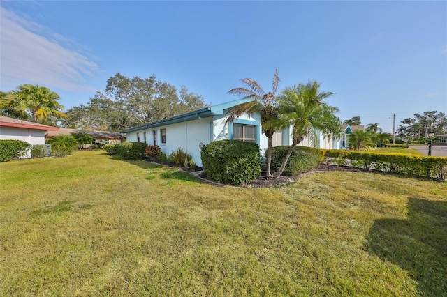 view of property exterior with a yard