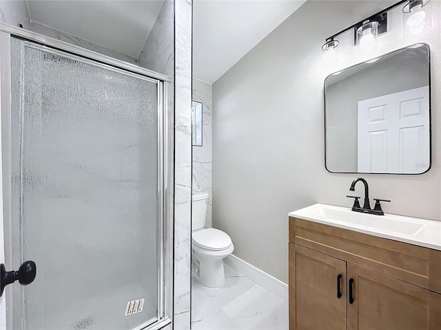 bathroom featuring vanity, toilet, and a shower with door