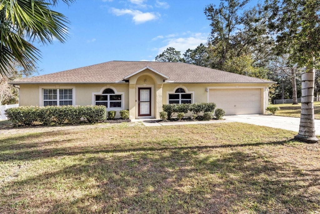 ranch-style home featuring a front yard and a garage