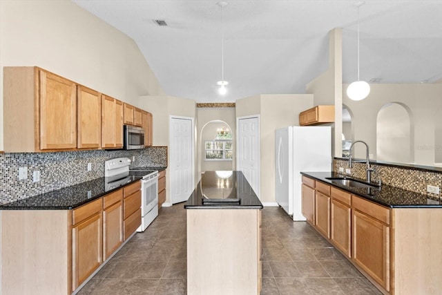 kitchen featuring sink, dark stone countertops, lofted ceiling, decorative light fixtures, and white appliances