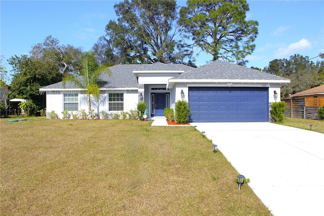 view of front of property with a garage and a front lawn