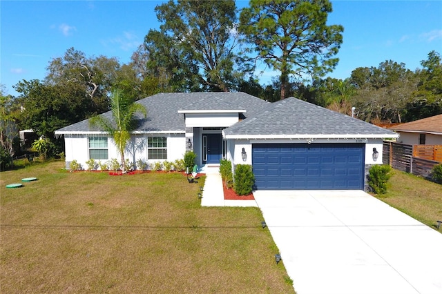 ranch-style house featuring a garage and a front lawn