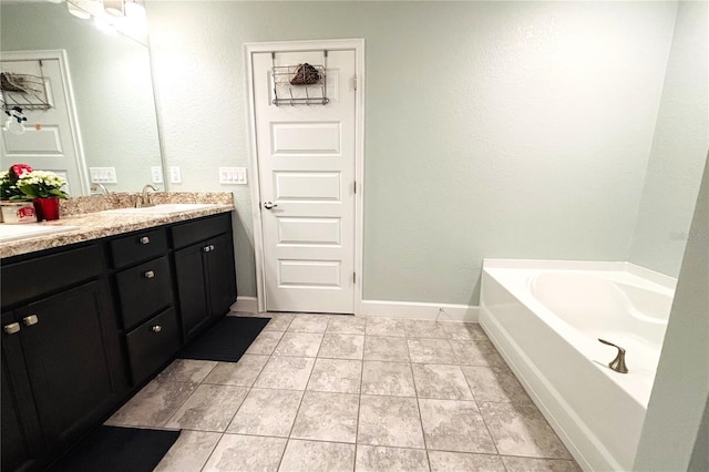 bathroom with tile patterned floors, vanity, and a tub to relax in