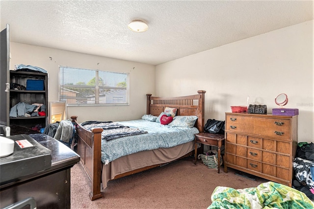 bedroom featuring carpet flooring and a textured ceiling