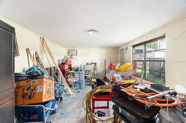 miscellaneous room featuring a textured ceiling and concrete floors