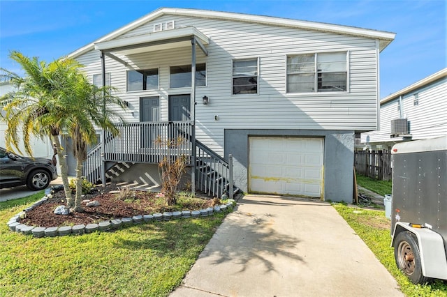 view of front of property featuring a garage, covered porch, concrete driveway, and stairs